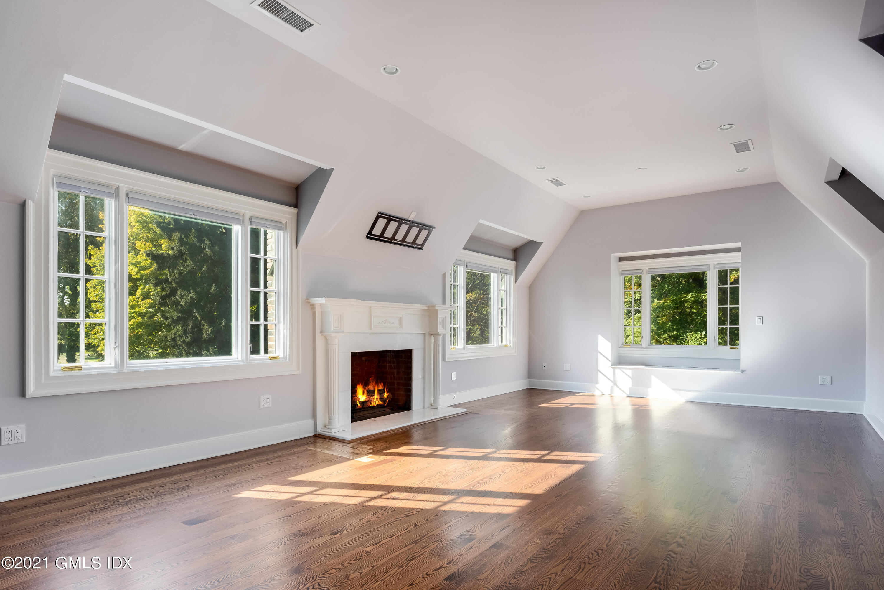 25 Doubling Road Greenwich, CT 06830 - Photo 16 of 30 a view of an empty room with wooden floor fireplace and a window