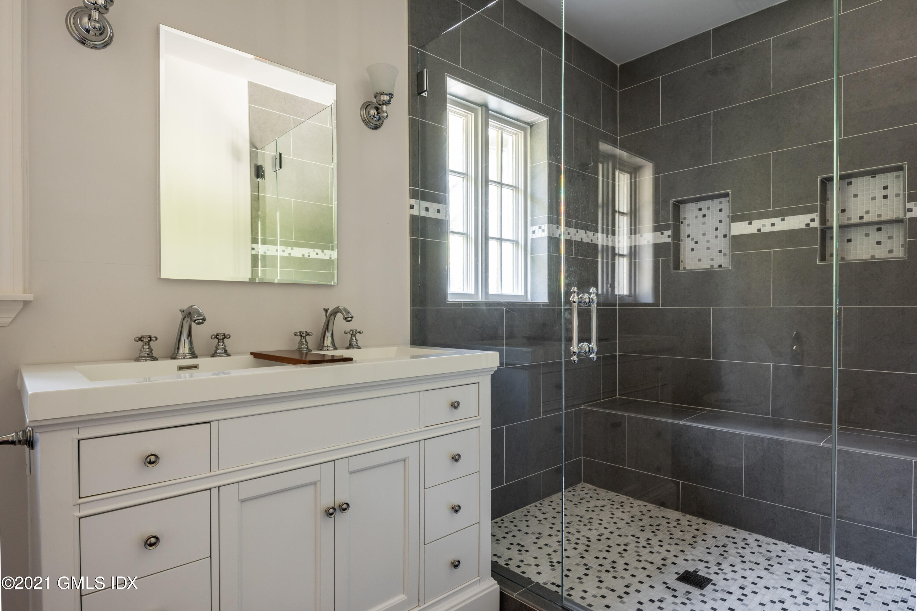 25 Doubling Road Greenwich, CT 06830 - Photo 18 of 30 a bathroom with a sink a toilet and a mirror