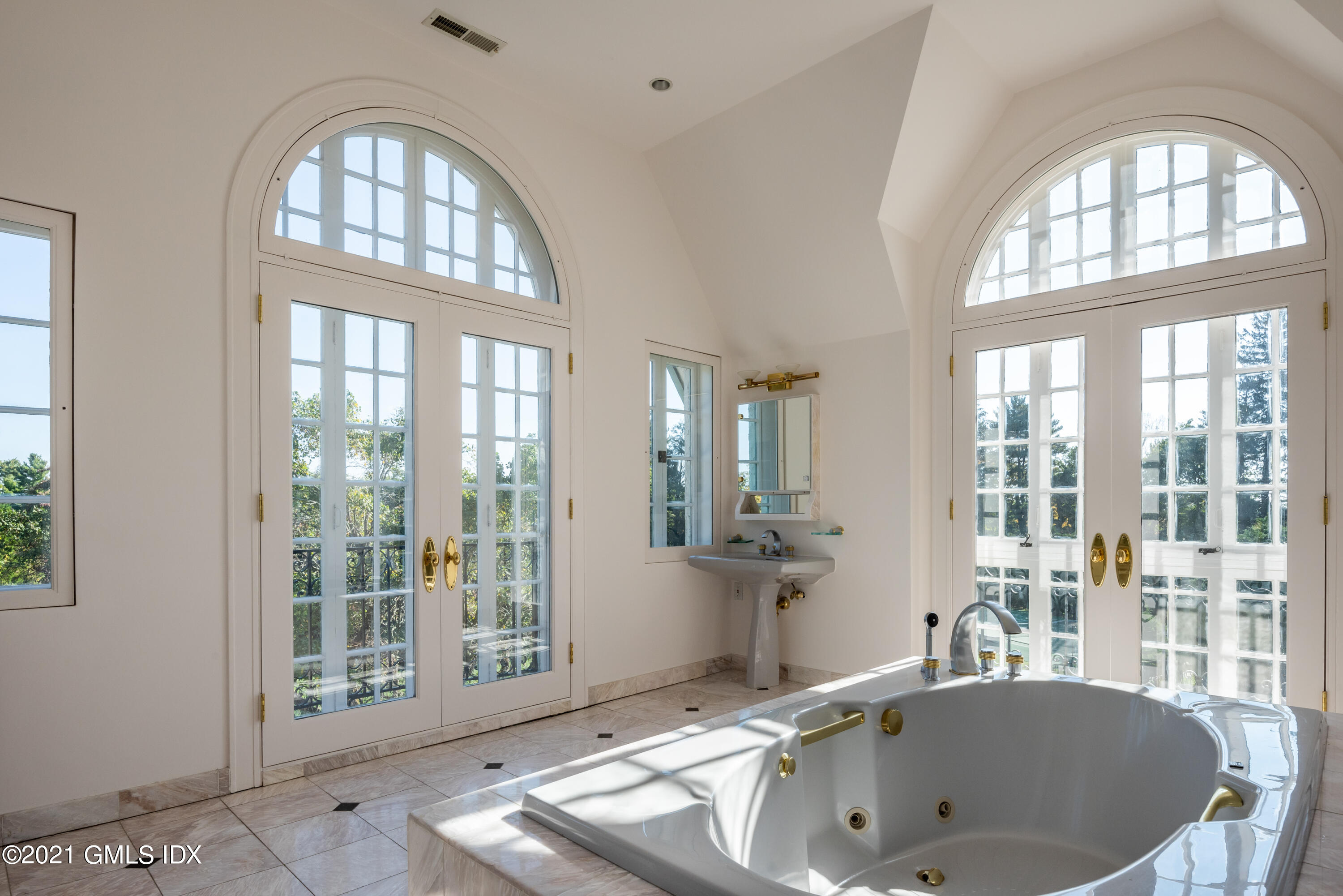 25 Doubling Road Greenwich, CT 06830 - Photo 19 of 30 a bathroom with a tub a sink and a large window