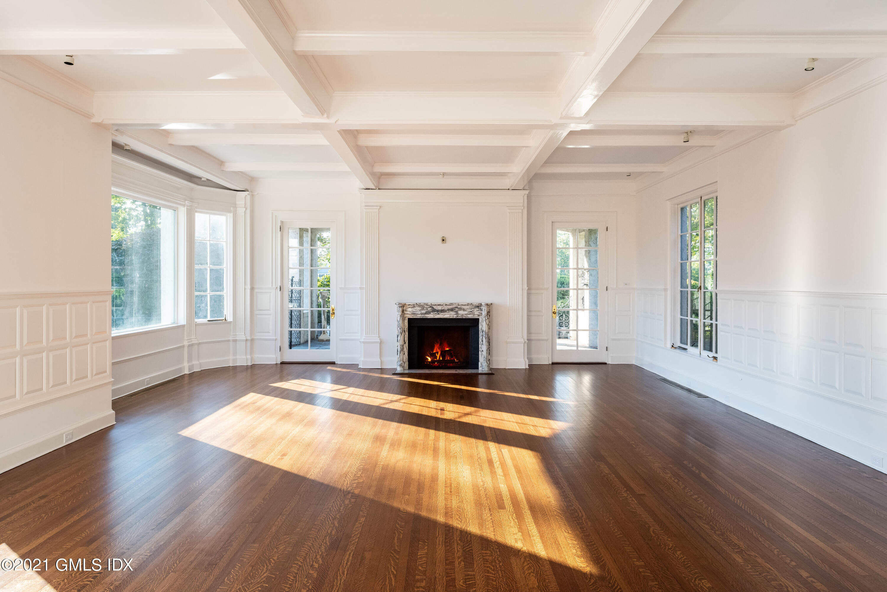 25 Doubling Road Greenwich, CT 06830 - Photo 6 of 30 a view of an empty room with wooden floor fireplace and a window