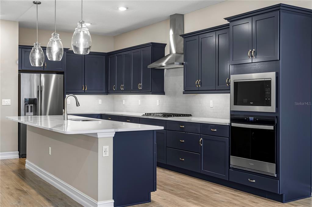 4474 Northwest 53rd Avenue Road Ocala, FL 34480 - Photo 12 of 78 a kitchen with stainless steel appliances granite countertop wooden cabinets a stove top oven a sink and dishwasher