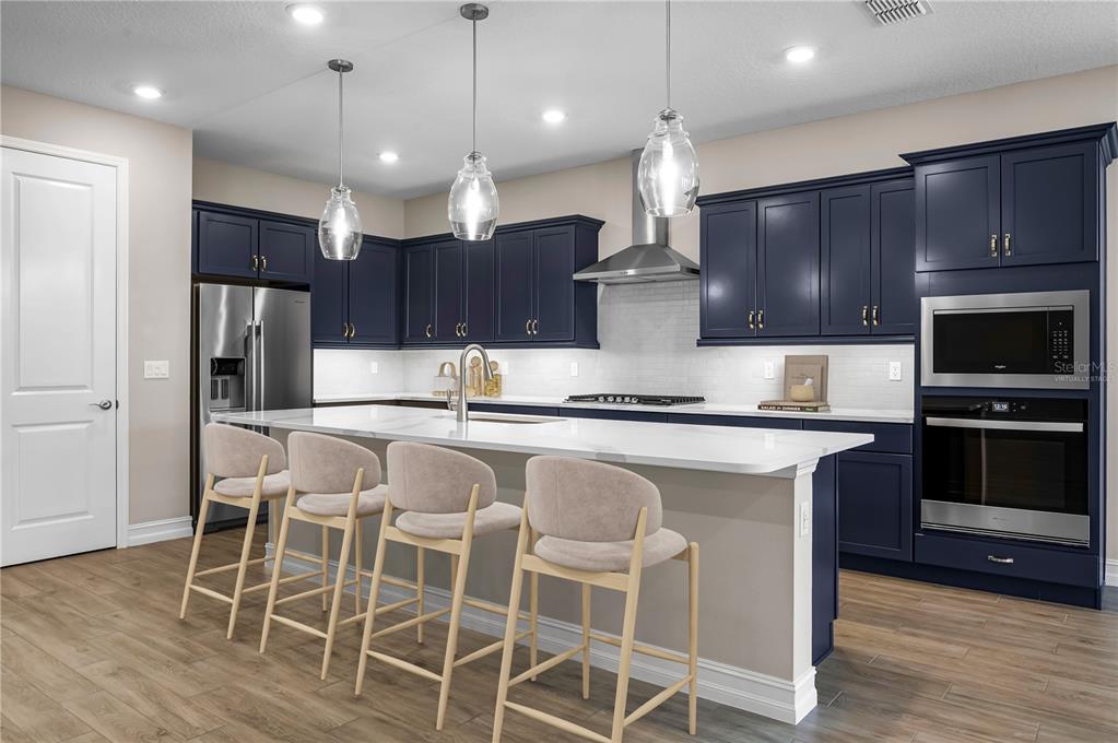 4474 Northwest 53rd Avenue Road Ocala, FL 34480 - Photo 14 of 78 a kitchen with stainless steel appliances kitchen island granite countertop a kitchen island hardwood floor and a sink