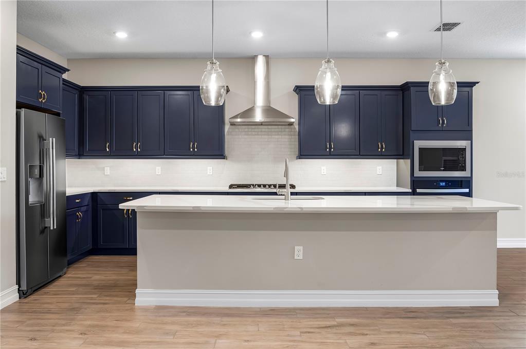 4474 Northwest 53rd Avenue Road Ocala, FL 34480 - Photo 17 of 78 a kitchen with a refrigerator and a wooden floor