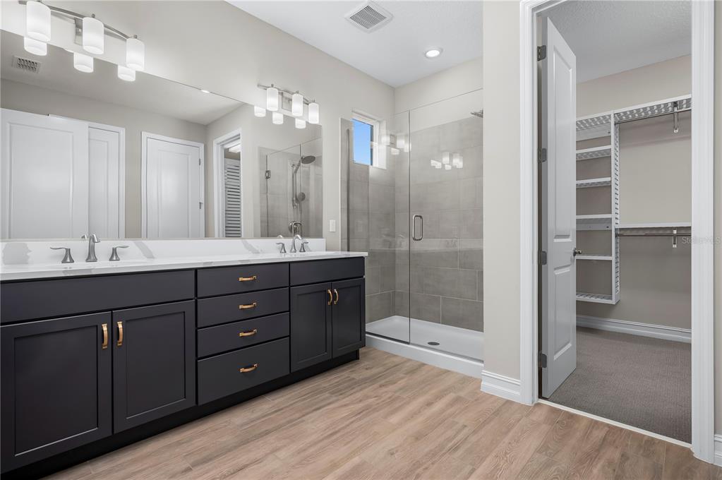 4474 Northwest 53rd Avenue Road Ocala, FL 34480 - Photo 27 of 78 a bathroom with a double vanity sink shower and a mirror