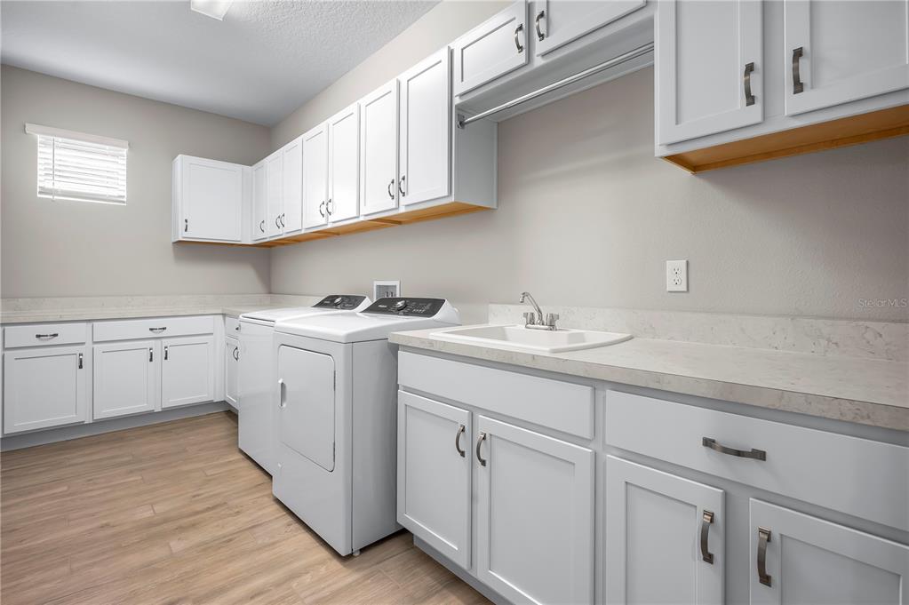4474 Northwest 53rd Avenue Road Ocala, FL 34480 - Photo 46 of 78 a kitchen with white cabinets stainless steel appliances and sink