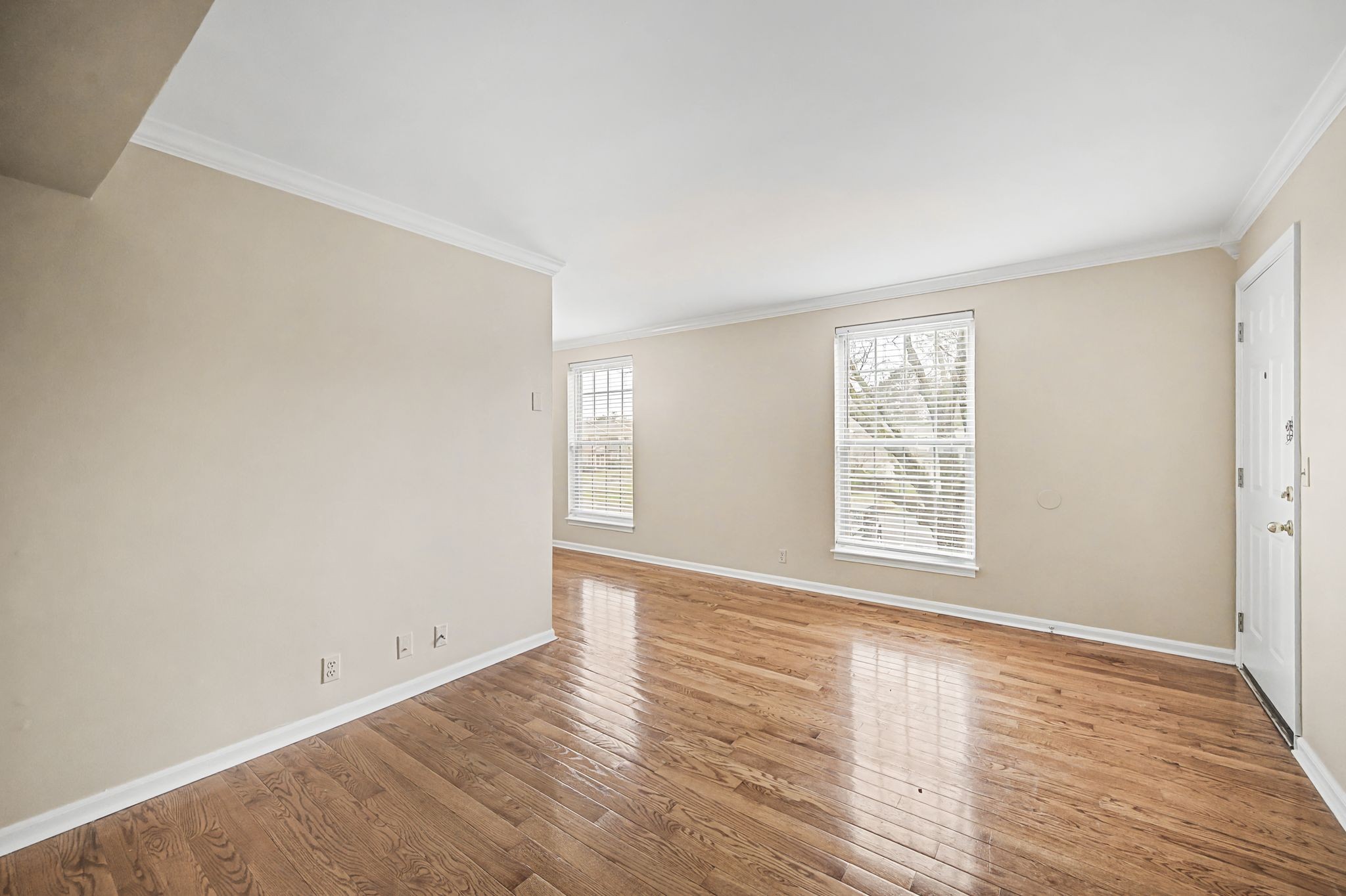 1011 Murfreesboro Road, Unit L10 Franklin, TN 37064 - Photo 12 of 47 an empty room with wooden floor and windows