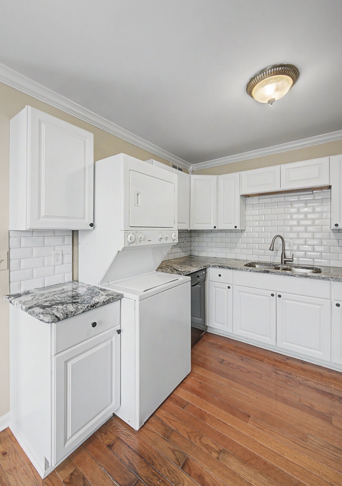 1011 Murfreesboro Road, Unit L10 Franklin, TN 37064 - Photo 18 of 47 a kitchen with granite countertop white cabinets and white appliances