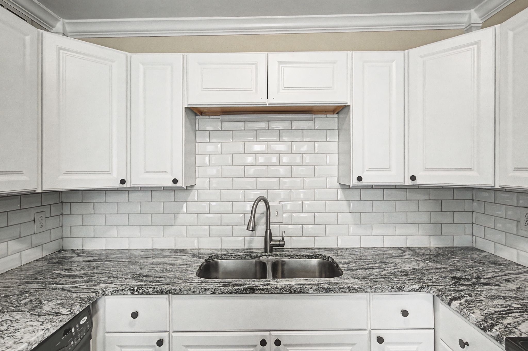 1011 Murfreesboro Road, Unit L10 Franklin, TN 37064 - Photo 21 of 47 a kitchen with granite countertop a sink and cabinets