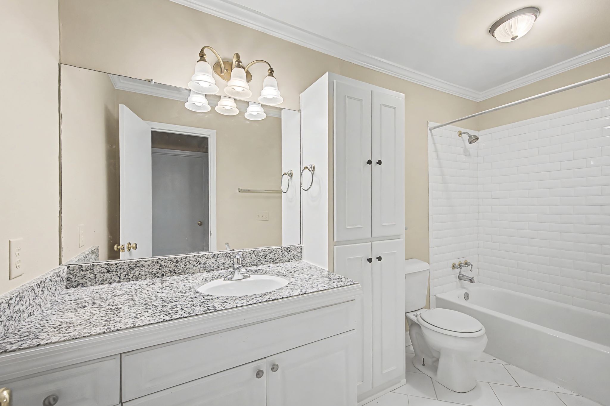 1011 Murfreesboro Road, Unit L10 Franklin, TN 37064 - Photo 29 of 47 a bathroom with a granite countertop sink a toilet a mirror and shower