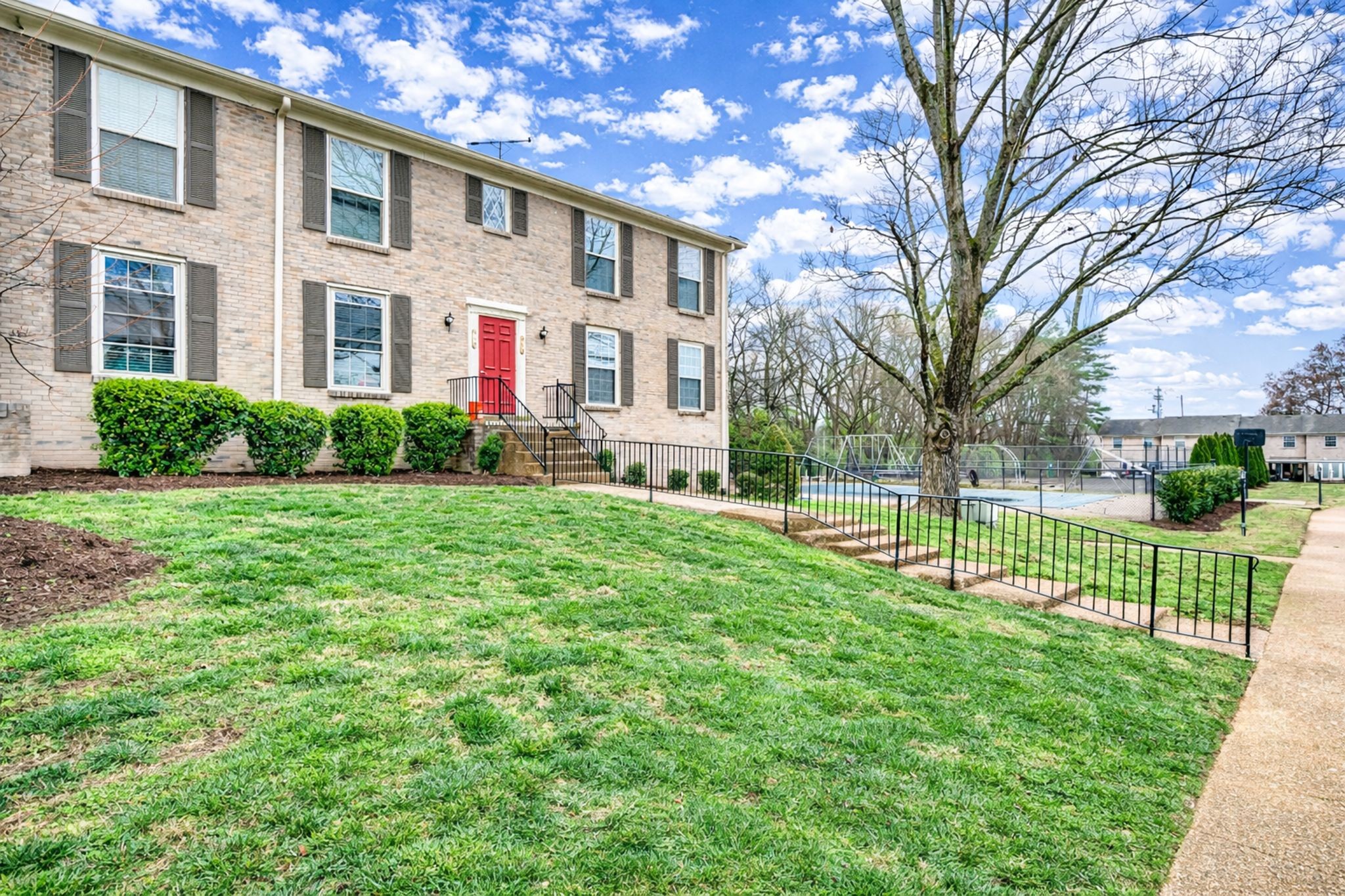 1011 Murfreesboro Road, Unit L10 Franklin, TN 37064 - Photo 3 of 47 a front view of house with yard and green space