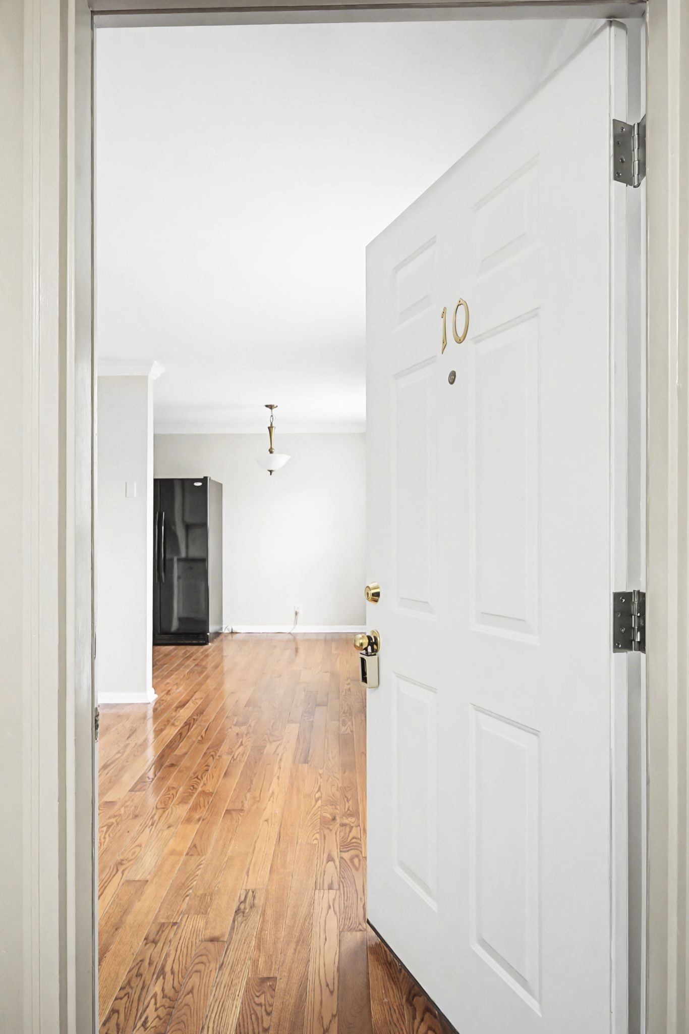 1011 Murfreesboro Road, Unit L10 Franklin, TN 37064 - Photo 7 of 47 a view of a big room with wooden floor and staircase