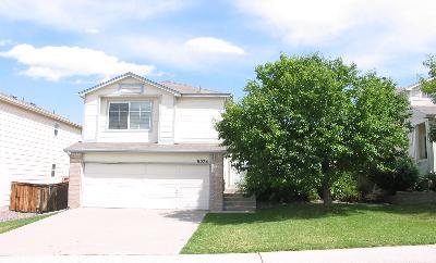 9578 South Castle Ridge Circle Highlands Ranch, CO 80129 - Photo 1 of 1 a front view of a house with a yard