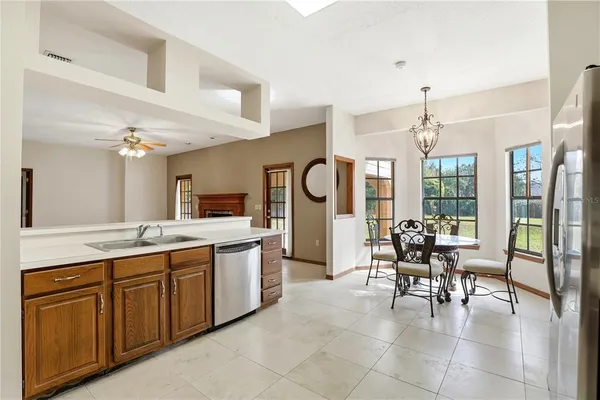 a dining room with furniture a chandelier and window