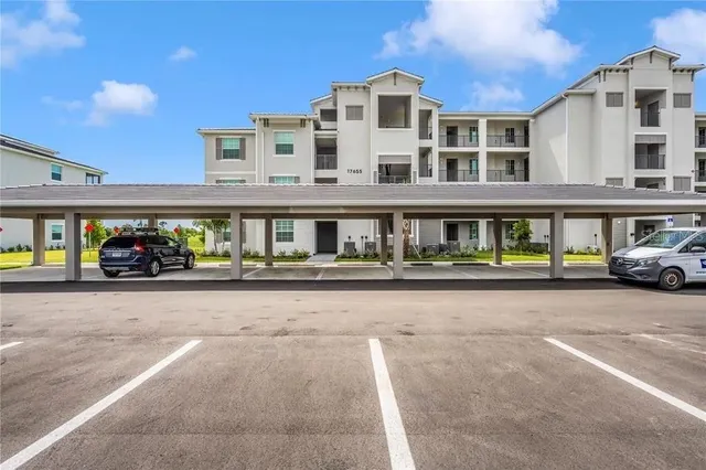 a view of building with car parked