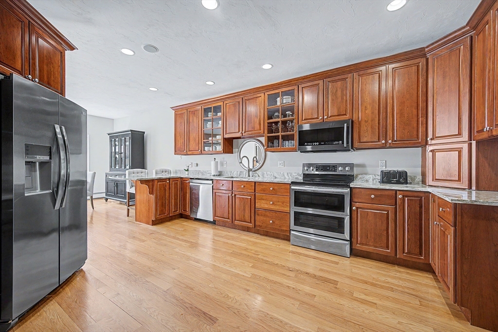 270 Mendon Road Sutton, MA 01590 - Photo 9 of 42 a large kitchen with stainless steel appliances granite countertop a stove a sink dishwasher and a refrigerator