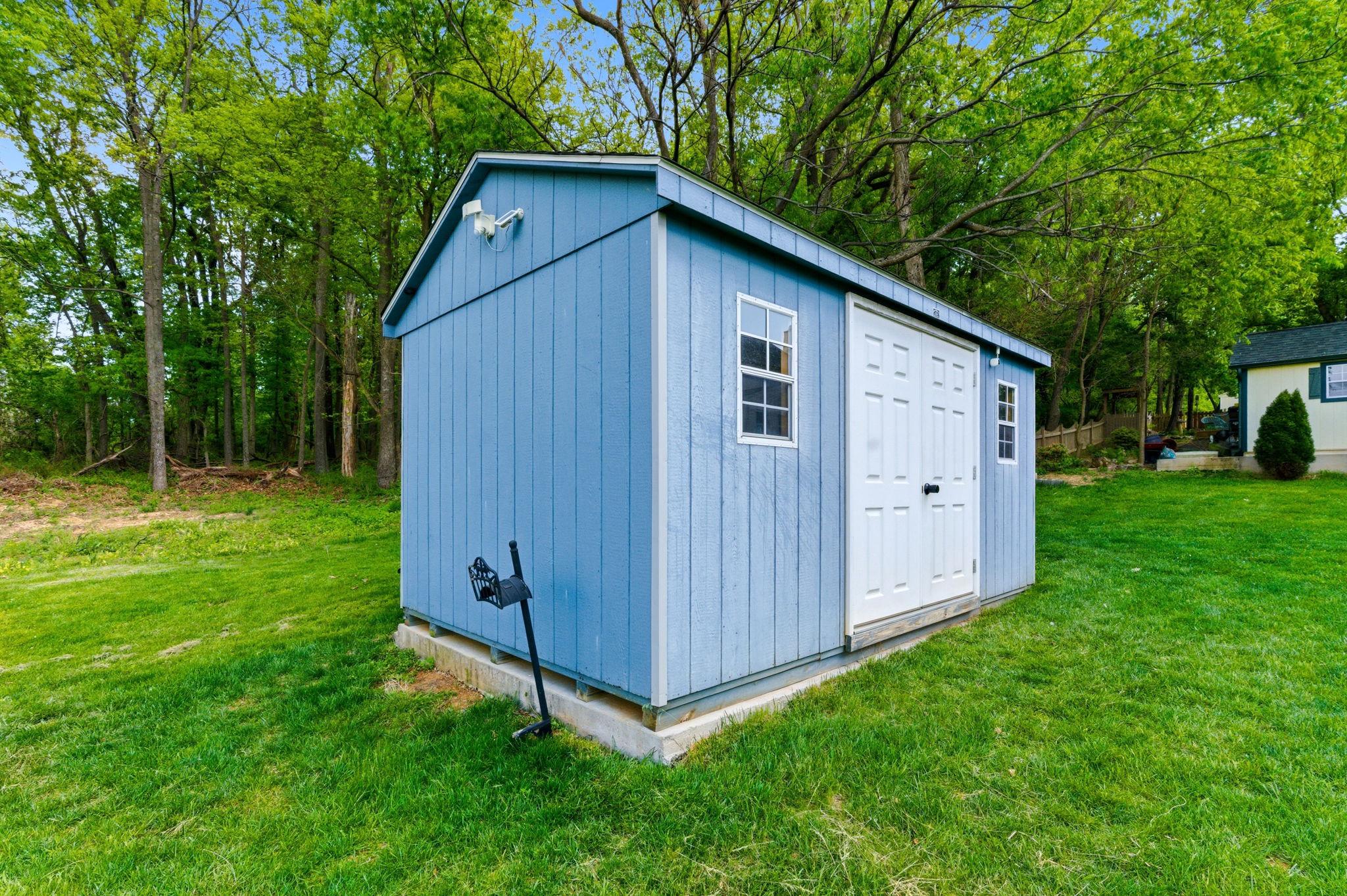 457 Hughs Road Charles Town, WV 25414 - Photo 61 of 73 Charming blue shed nestled in greenery.