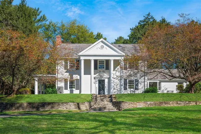 a front view of a house with a yard table and chairs