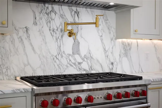 a room with a stove and a shower curtain