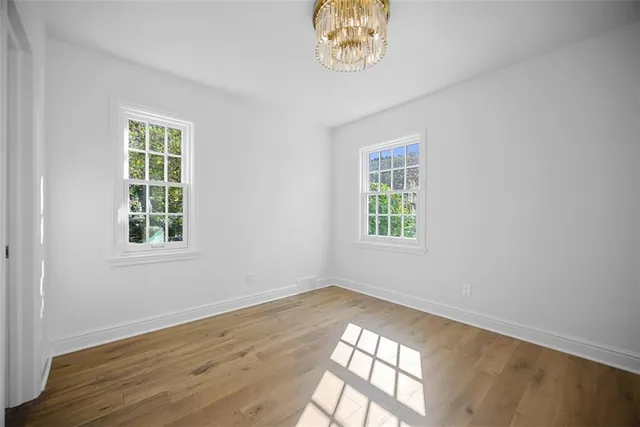 wooden floor in an empty room with a window