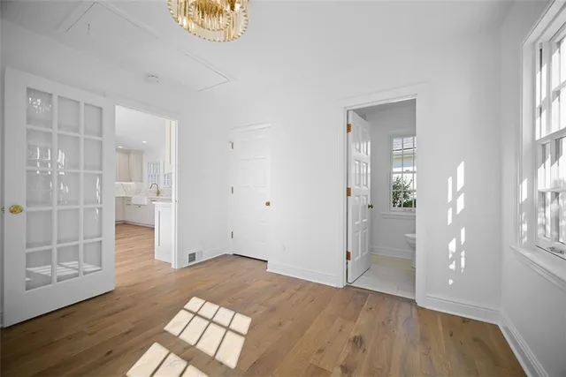 a bathroom with a granite countertop sink toilet and mirror