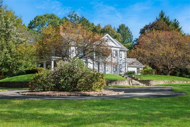 a front view of a house with a yard table and chairs