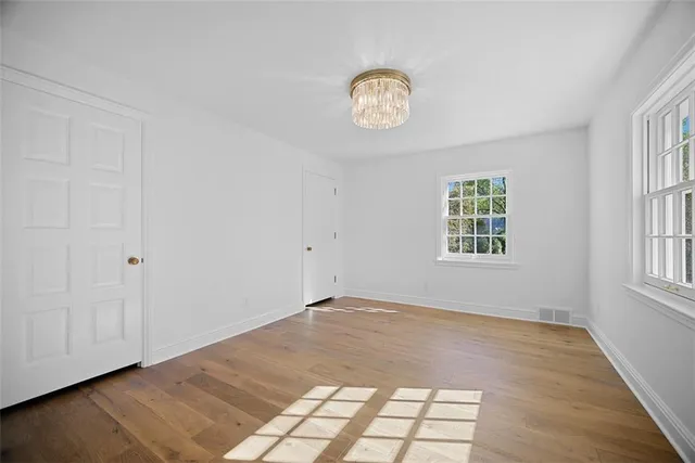 a view of a room with wooden floor and natural light