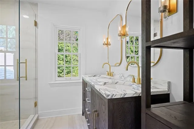 a bathroom with a glass shower door