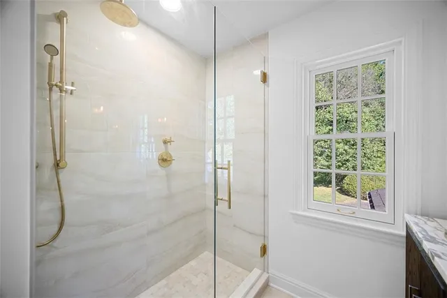 a view of empty room with wooden floor and fireplace