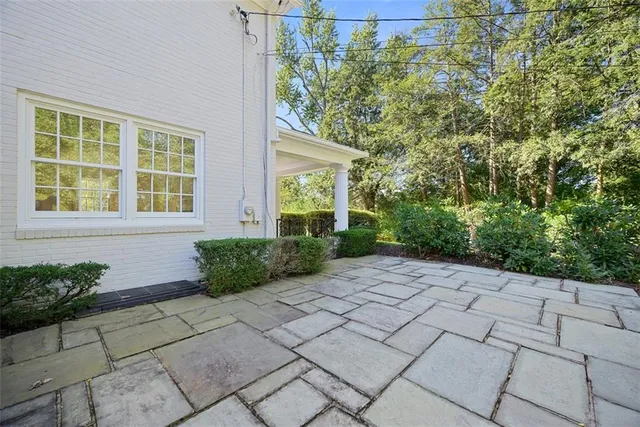 a view of a house with backyard and a porch