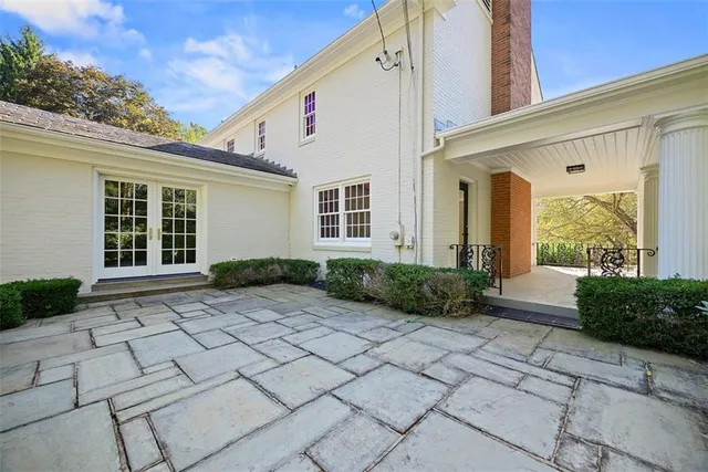 a view of a house with a patio and a yard