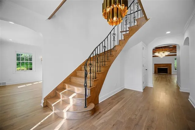 a view of entryway and hall with wooden floor