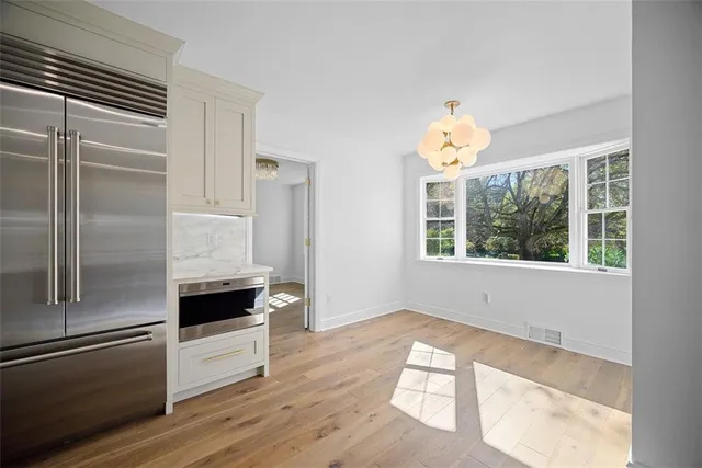 a kitchen with granite countertop a refrigerator and a stove