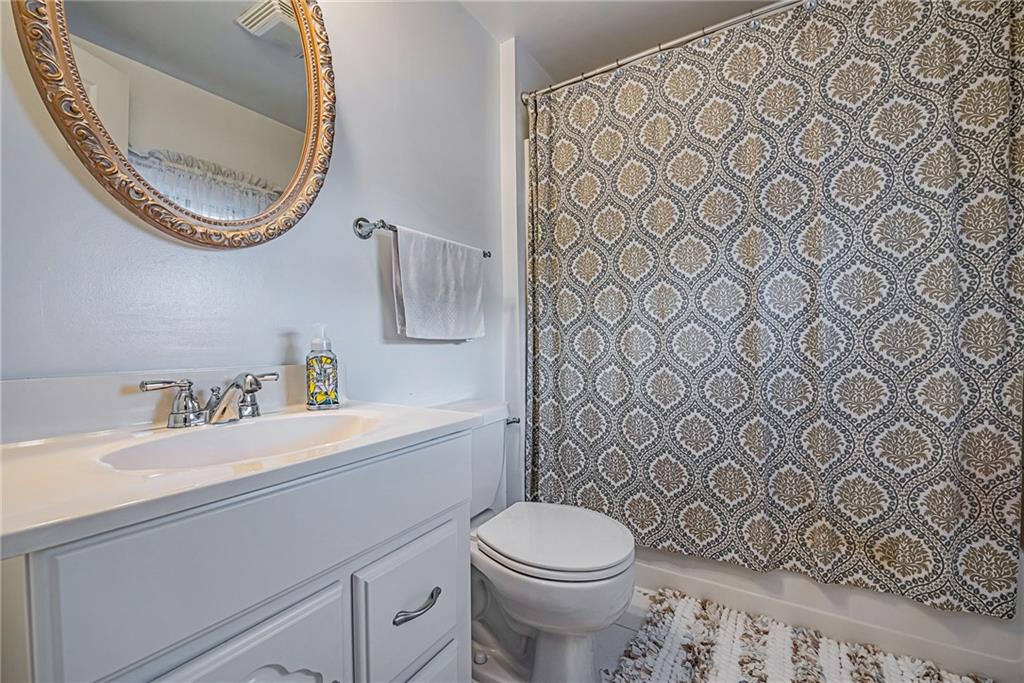 210 Grant Street North Huntingdon, PA 15642 - Photo 15 of 18 a bathroom with a sink a toilet and a mirror