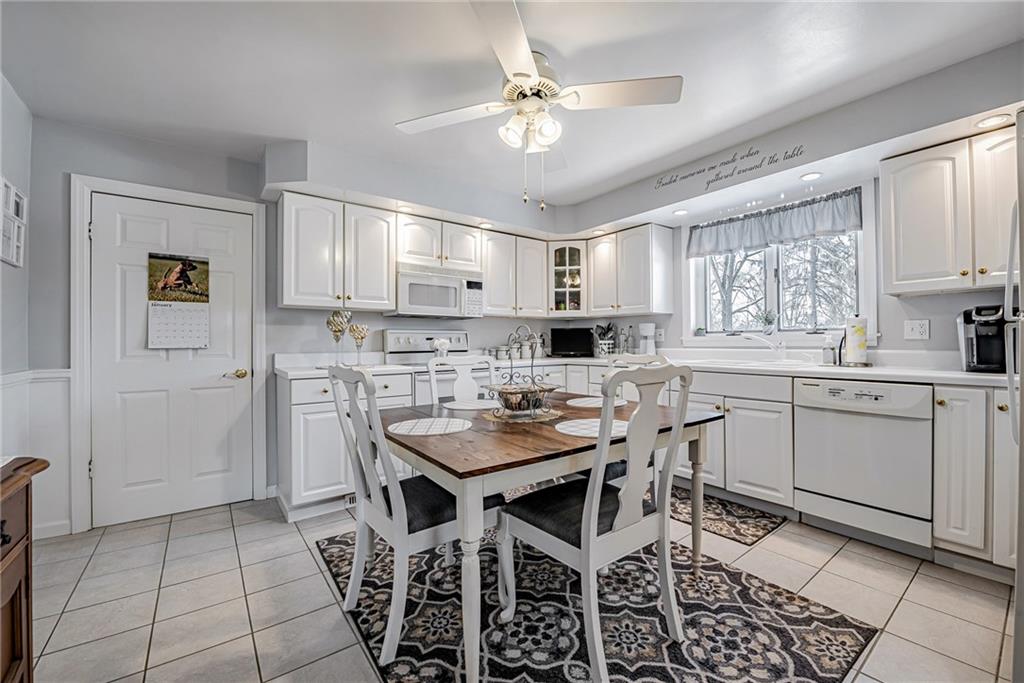 210 Grant Street North Huntingdon, PA 15642 - Photo 8 of 18 a kitchen with a dining table chairs cabinets and stainless steel appliances
