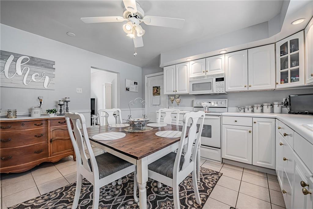 210 Grant Street North Huntingdon, PA 15642 - Photo 9 of 18 a kitchen with a dining table chairs and cabinets