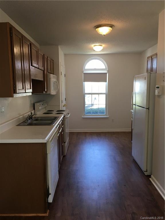 4306 Lothar Ridge Lane Charlotte, NC 28216 - Photo 3 of 22 a kitchen that has a sink and a stove in it