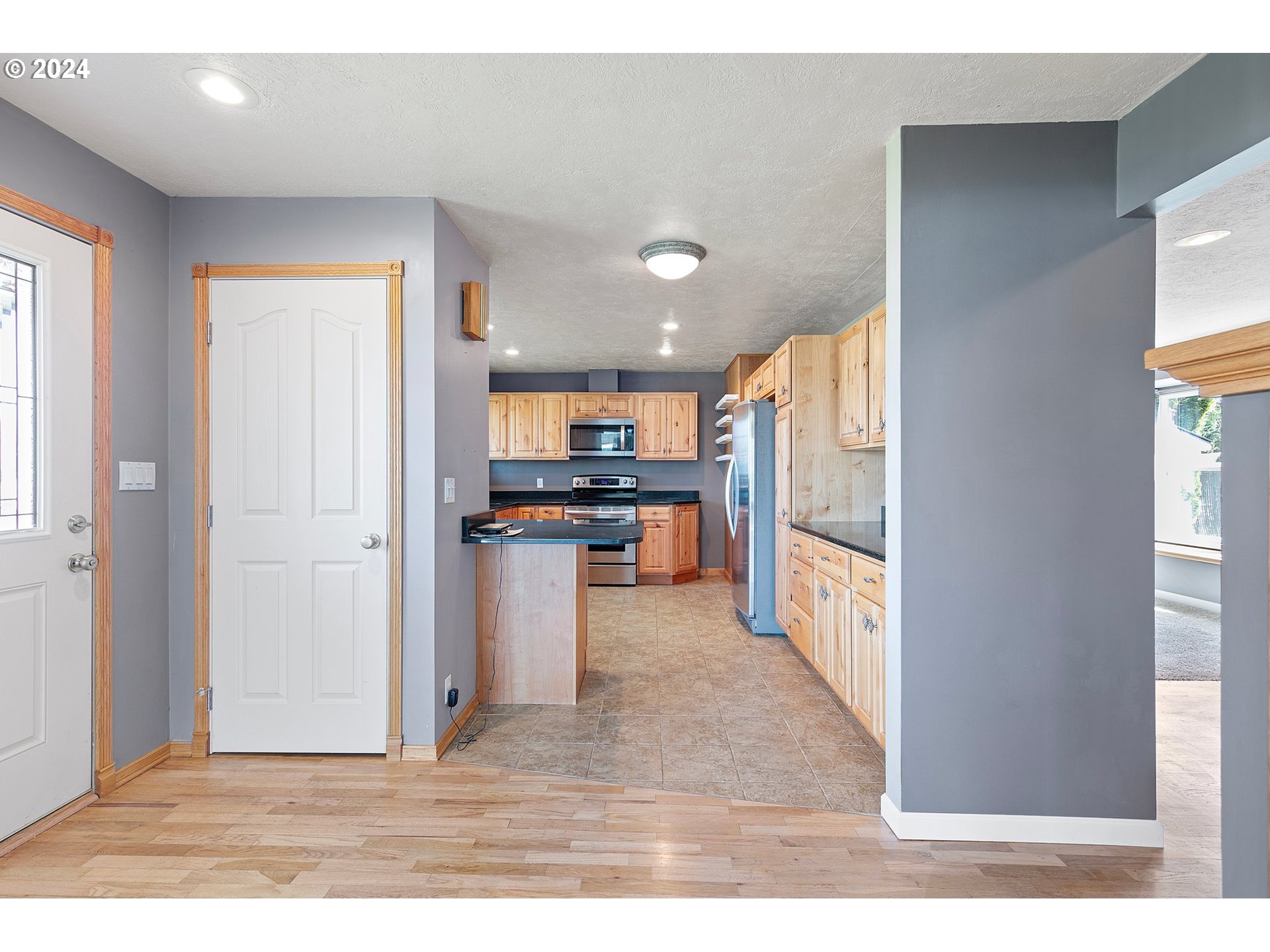 1355 M Street Springfield, OR 97477 - Photo 11 of 43 a view of kitchen with stainless steel appliances kitchen island refrigerator stove and cabinets