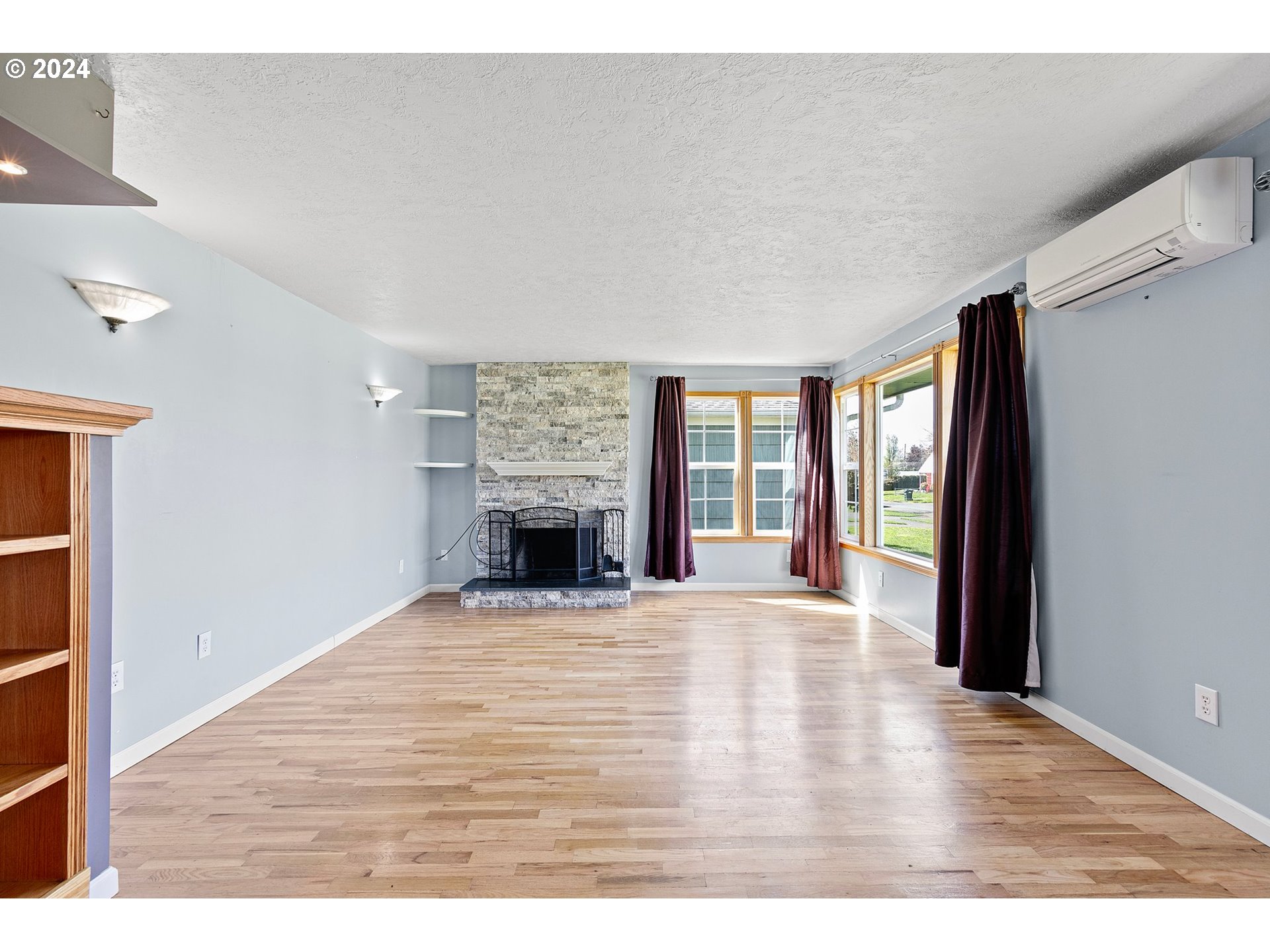 1355 M Street Springfield, OR 97477 - Photo 5 of 43 a view of an empty room with a fireplace and a window