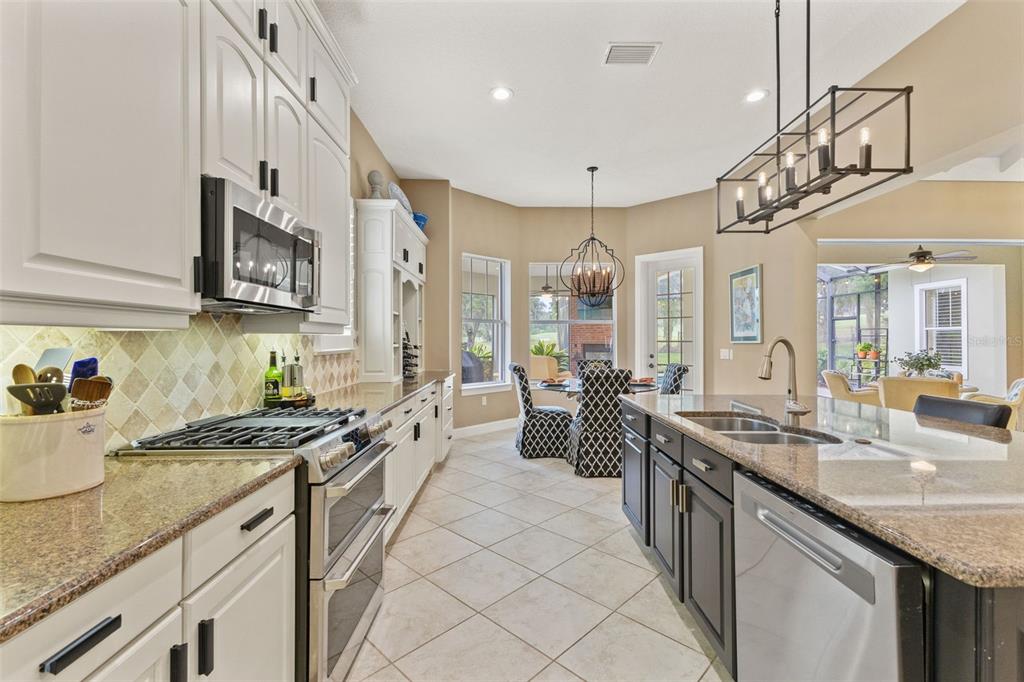 4978 Southern Valley Loop Brooksville, FL 34601 - Photo 16 of 78 a kitchen with stainless steel appliances granite countertop a sink stove and cabinets