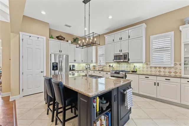a living room with furniture a flat screen tv and a table
