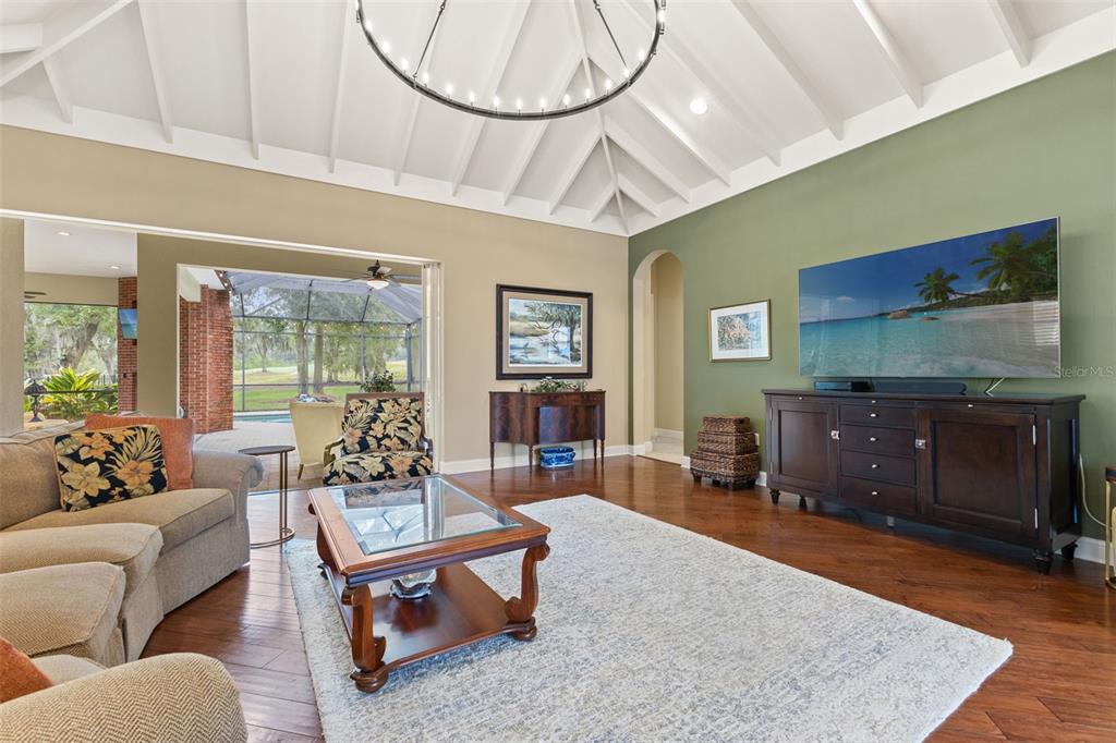 4978 Southern Valley Loop Brooksville, FL 34601 - Photo 22 of 78 a living room with furniture a chandelier and a wooden floor