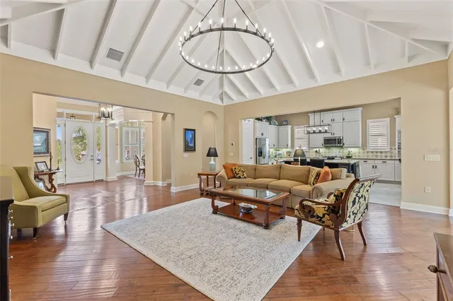 a front view of a house with a yard and potted plants