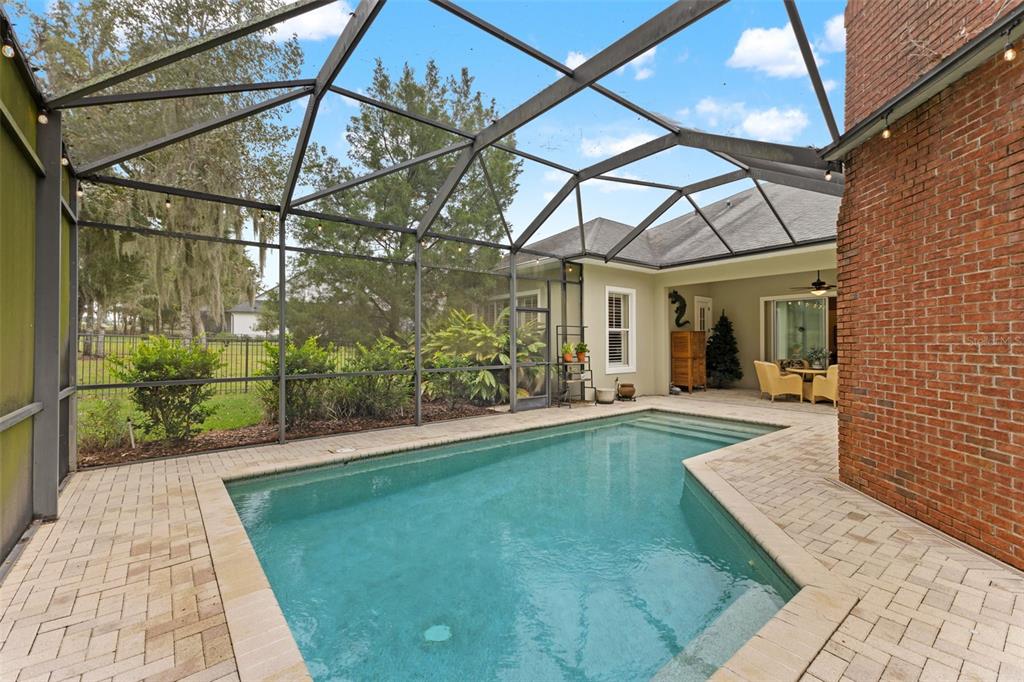 4978 Southern Valley Loop Brooksville, FL 34601 - Photo 37 of 78 a view of a white house with a small yard and wooden floor and fence