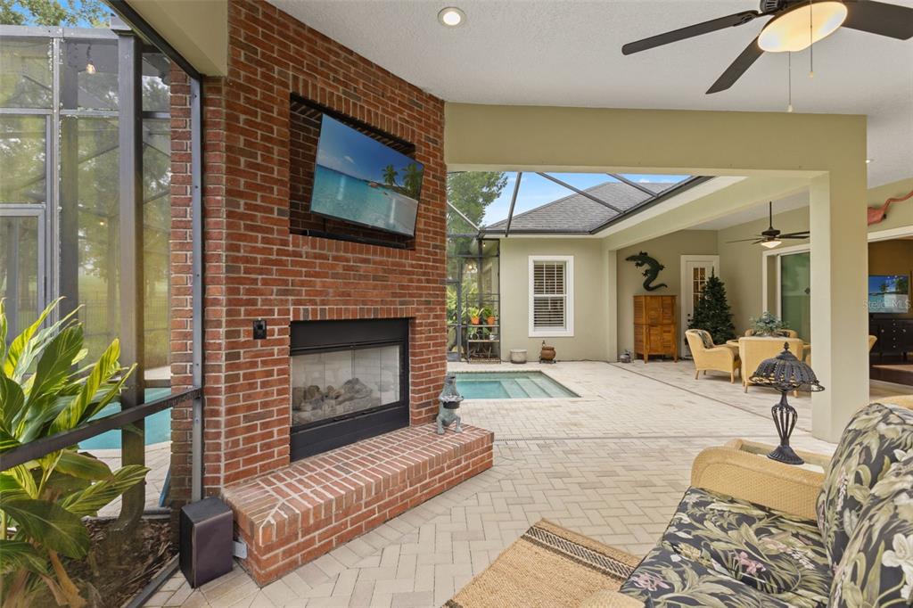 4978 Southern Valley Loop Brooksville, FL 34601 - Photo 38 of 78 a living room with furniture a flat screen tv and a fireplace