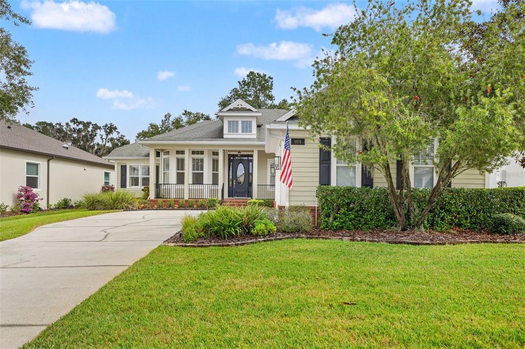 4978 Southern Valley Loop Brooksville, FL 34601 - Photo 4 of 78 a front view of a house with a yard and potted plants