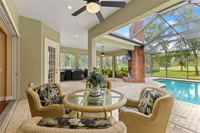 a view of a swimming pool with an outdoor space and seating area