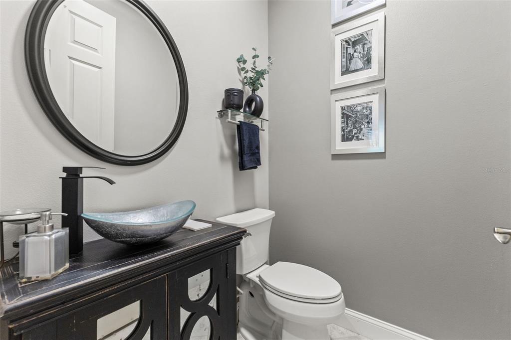 4978 Southern Valley Loop Brooksville, FL 34601 - Photo 49 of 78 a bathroom with a toilet a sink and a mirror