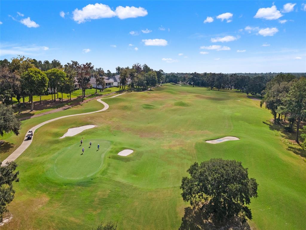 4978 Southern Valley Loop Brooksville, FL 34601 - Photo 61 of 78 a view of a swimming pool with an outdoor space and seating area