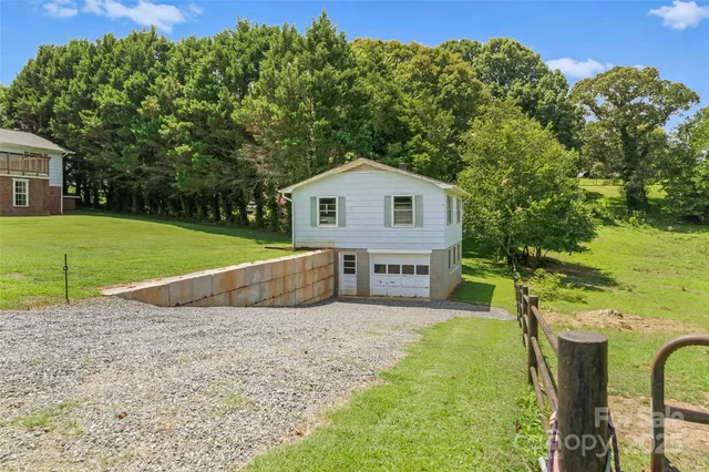 a view of a house with a yard and sitting area