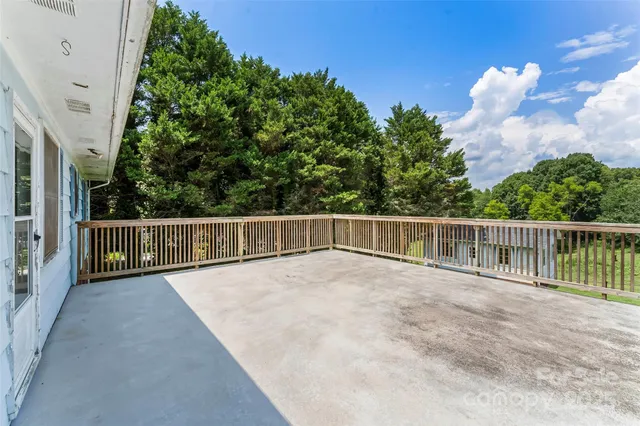 a view of a house with a wooden deck